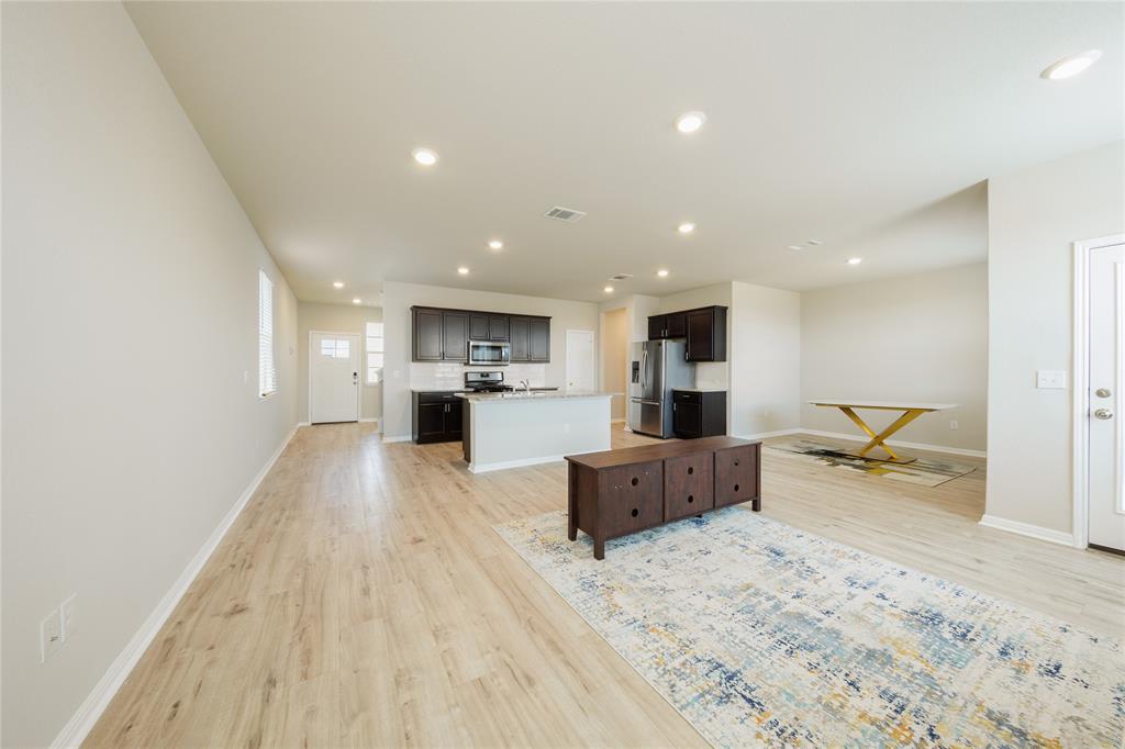 521 Otto Avenue Georgetown, TX 78626 - Photo 36 of 38 Kitchen with light countertops, open floor plan, light wood finished floors, a center island with sink, and recessed lighting