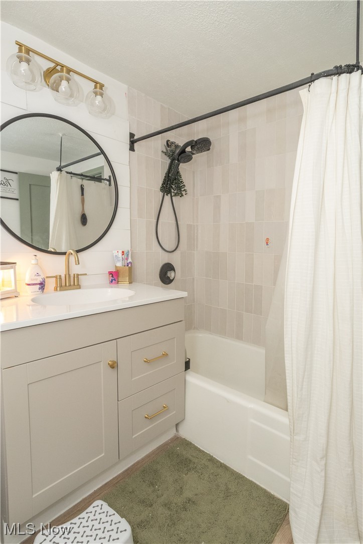 134 Raff Road Northwest Canton, OH 44708 - Photo 13 of 28 Bathroom featuring shower / tub combo, vanity, and a textured ceiling