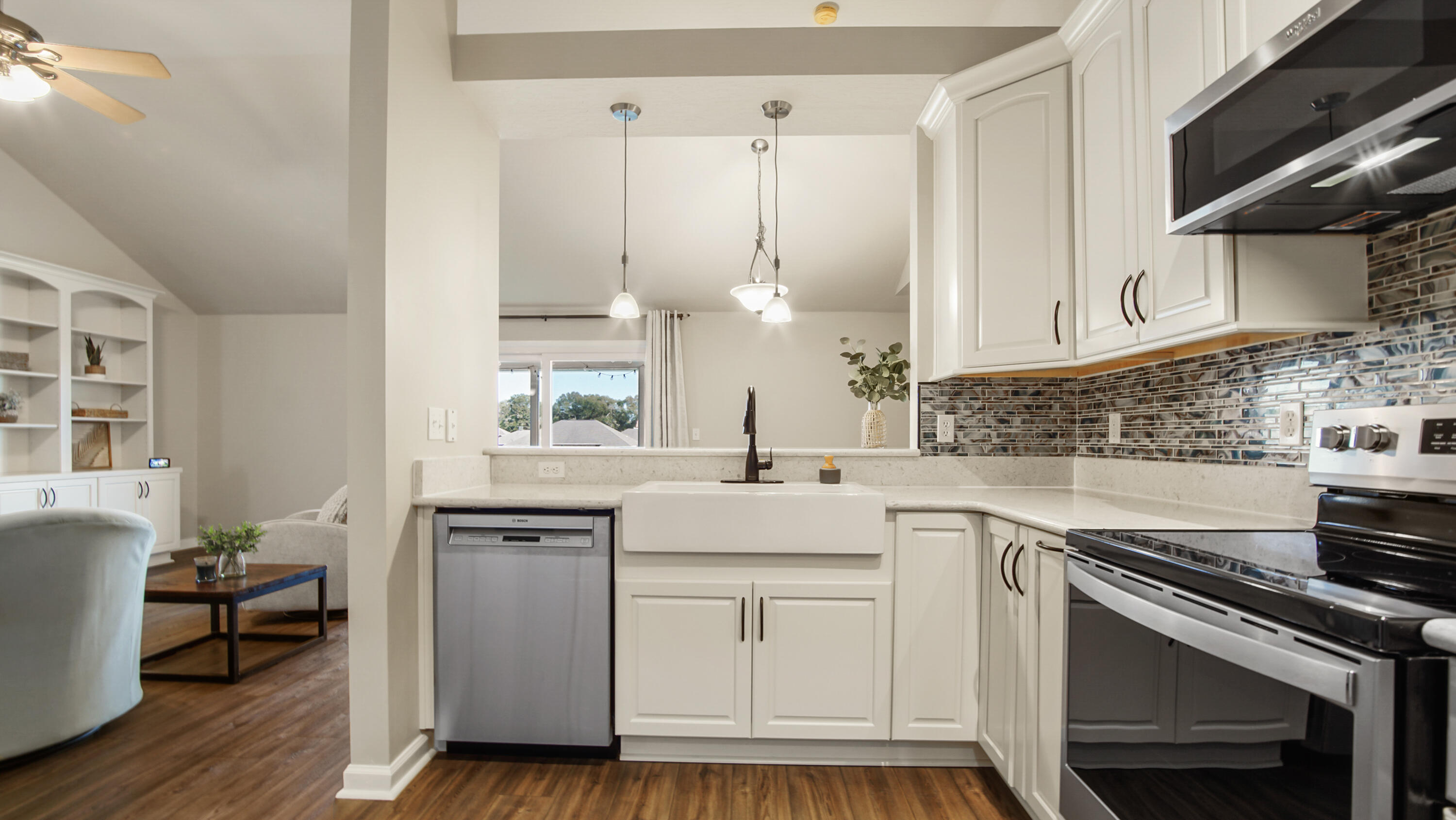 5227 Moore Loop Crestview, FL 32536 - Photo 13 of 43 a kitchen with kitchen island granite countertop a sink cabinets and stainless steel appliances