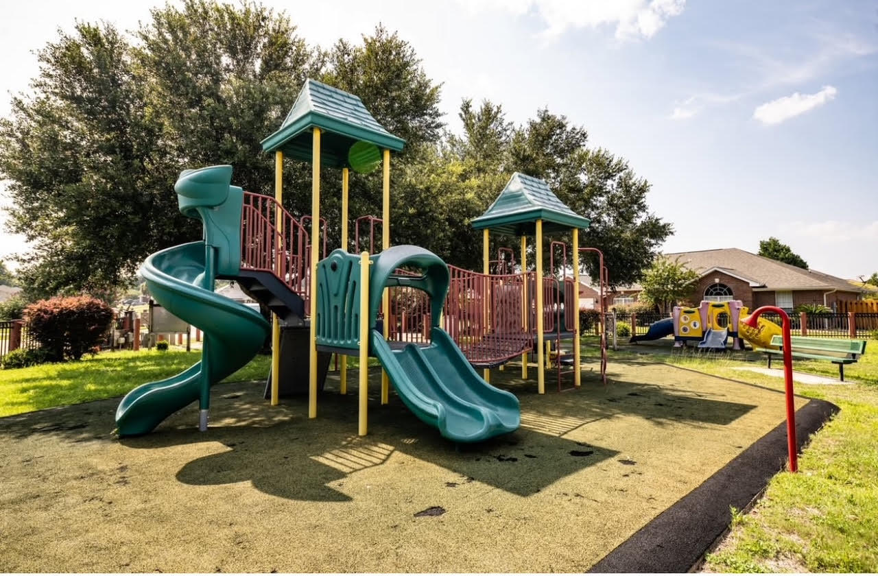 5227 Moore Loop Crestview, FL 32536 - Photo 42 of 43 a front view of a house with garden and sitting area