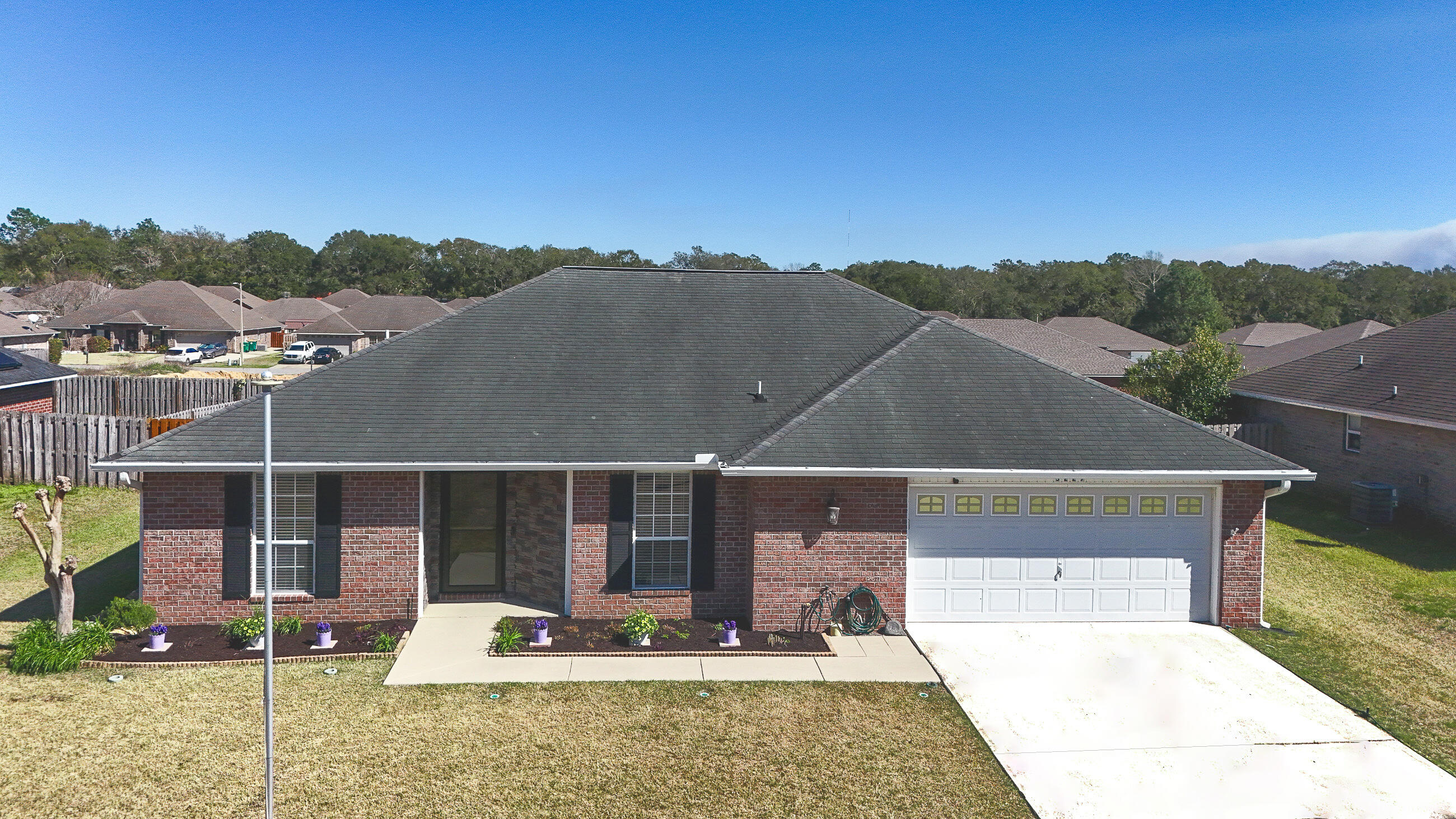 5227 Moore Loop Crestview, FL 32536 - Photo 6 of 43 a view of a terrace with a bench and floor to ceiling window