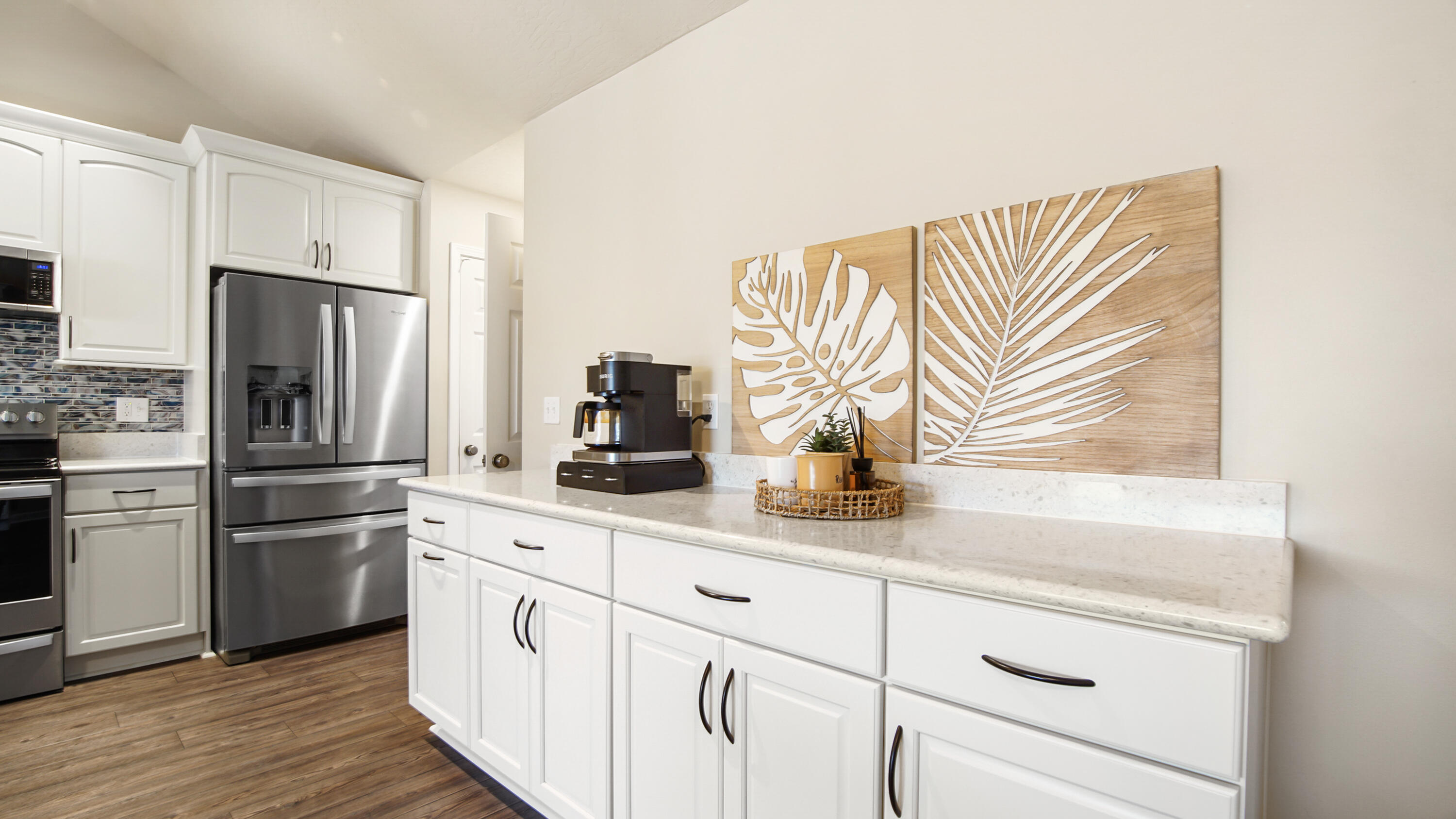 5227 Moore Loop Crestview, FL 32536 - Photo 10 of 43 a kitchen with granite countertop white cabinets and stainless steel appliances