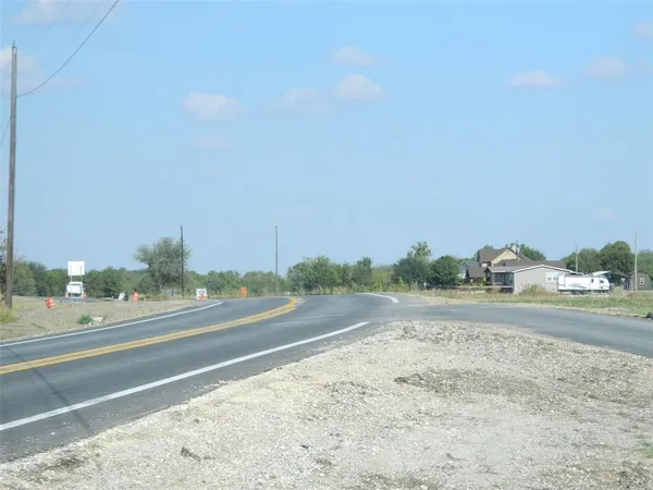 a view of a road with a yard