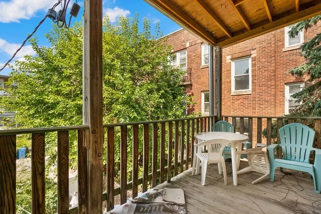 a view of a chair and table in the balcony