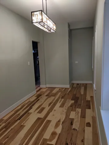 a view of a room with wooden floor