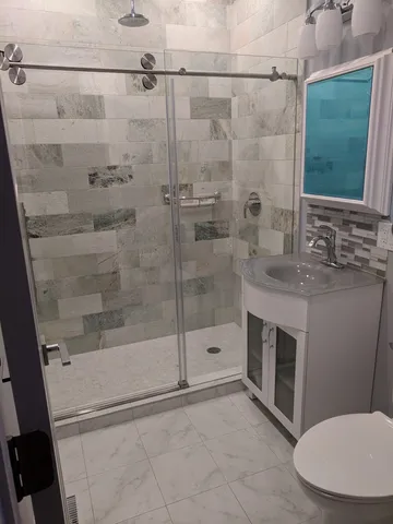 a bathroom with a shower and a sink