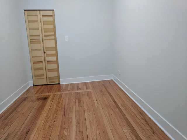 an empty room with wooden floor