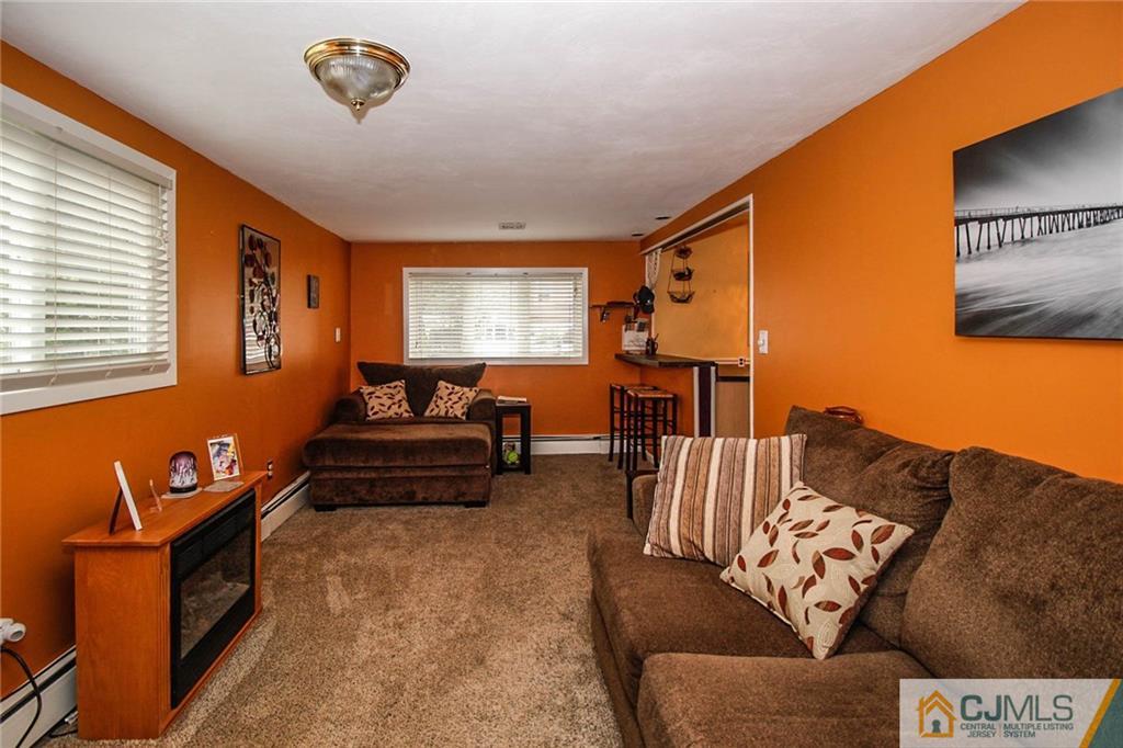 24 Raleigh Road Edison, NJ 08817 - Photo 14 of 25 a living room with furniture and a flat screen tv