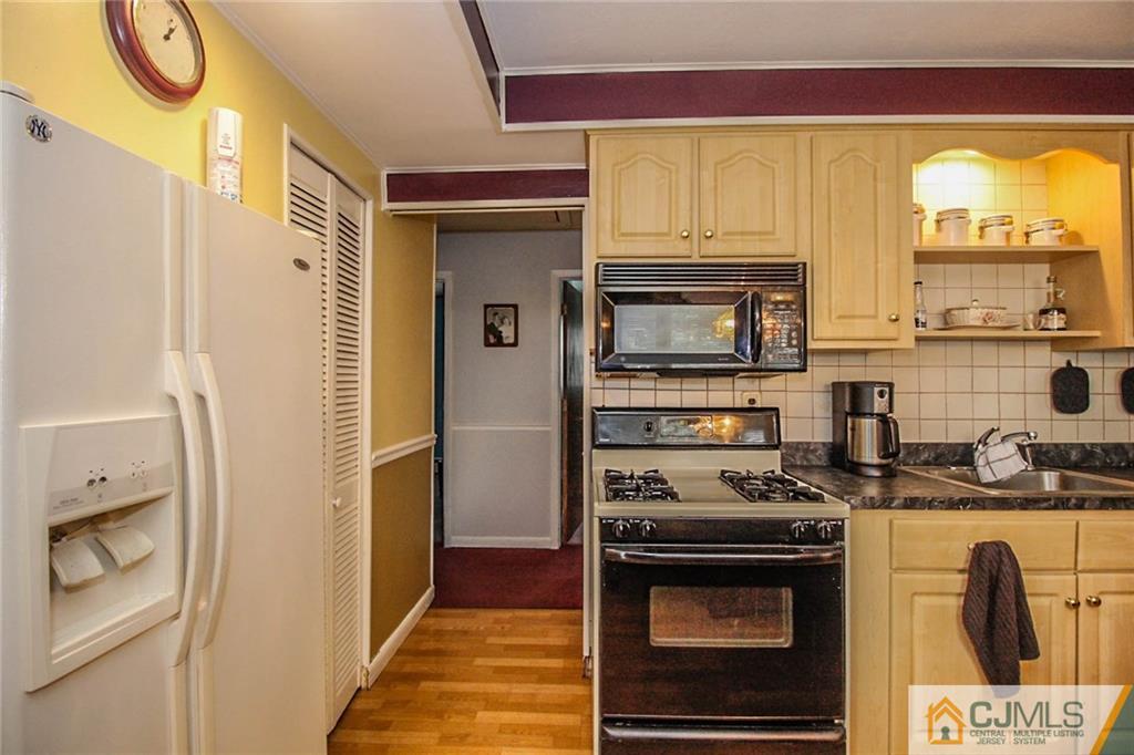 24 Raleigh Road Edison, NJ 08817 - Photo 8 of 25 a kitchen with stainless steel appliances granite countertop a stove and a refrigerator