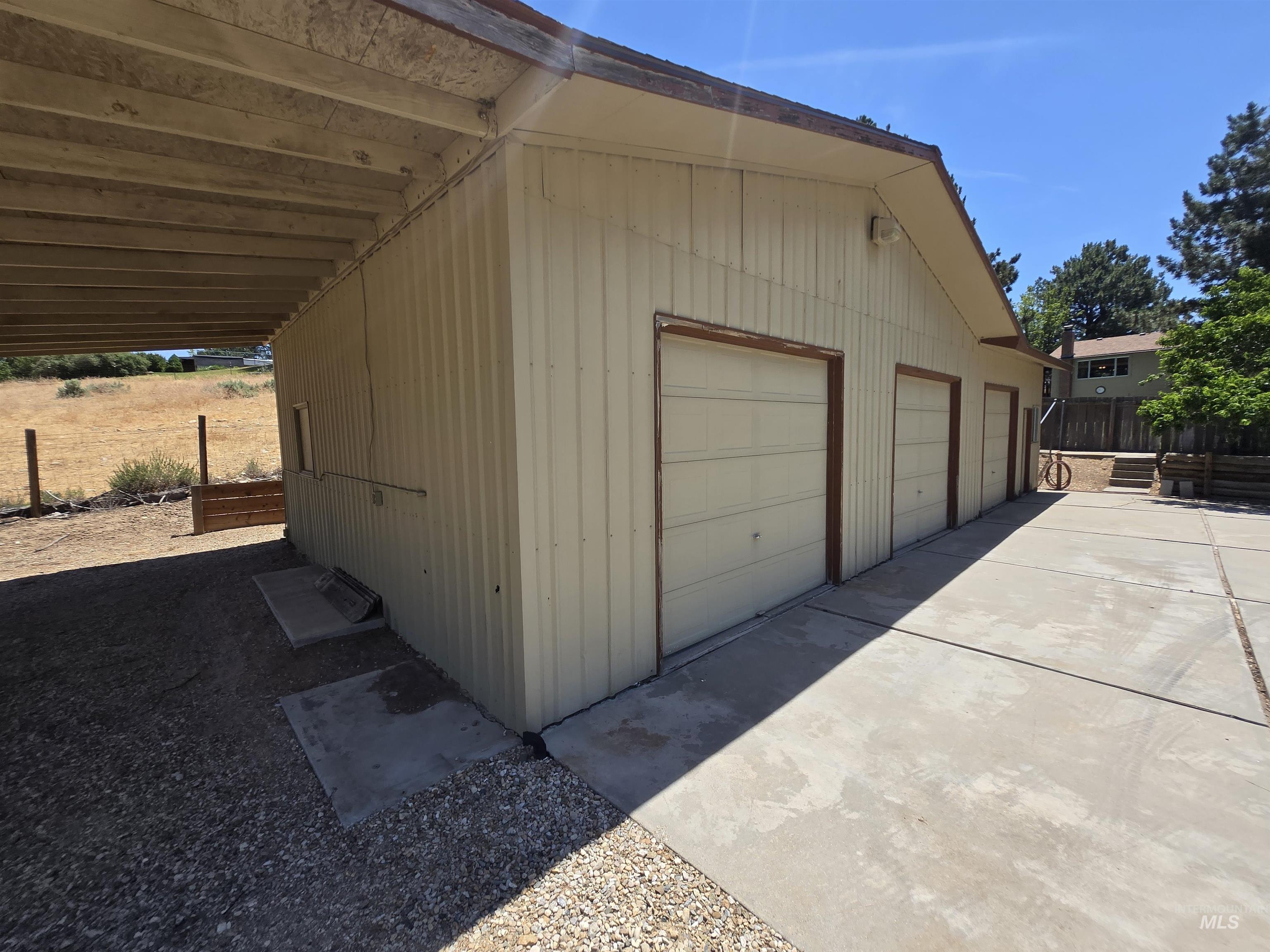 12050 West Hidden Valley Rim Road Boise, ID 83709 - Photo 33 of 39 Detached structure featuring three garage doors and corrugated metal siding