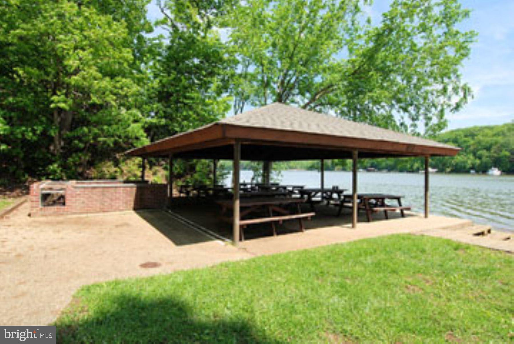 3484 Olympia Road Davidsonville, MD 21035 - Photo 48 of 50 a view of backyard with table and chairs under an umbrella