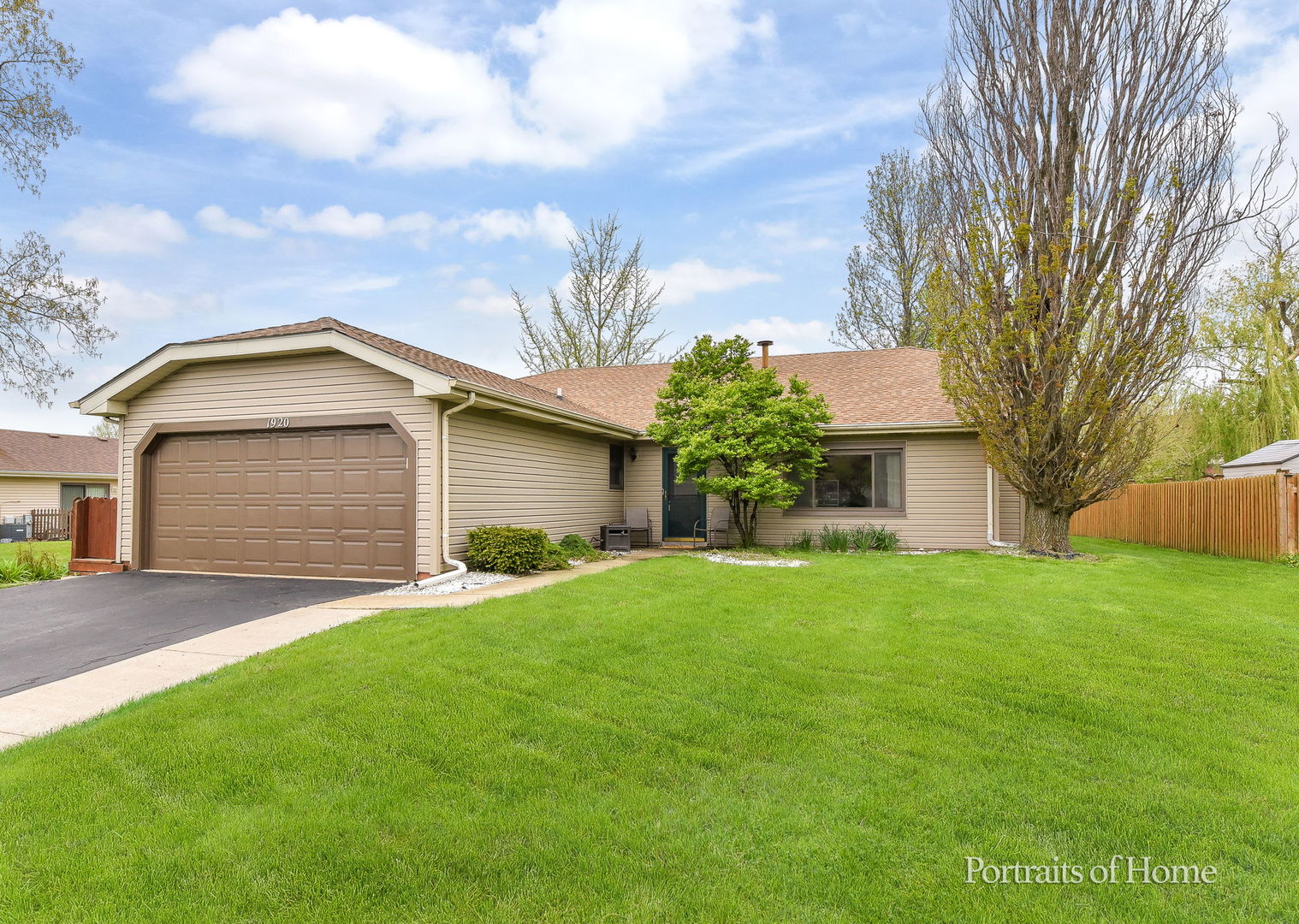 a front view of house with yard and trees
