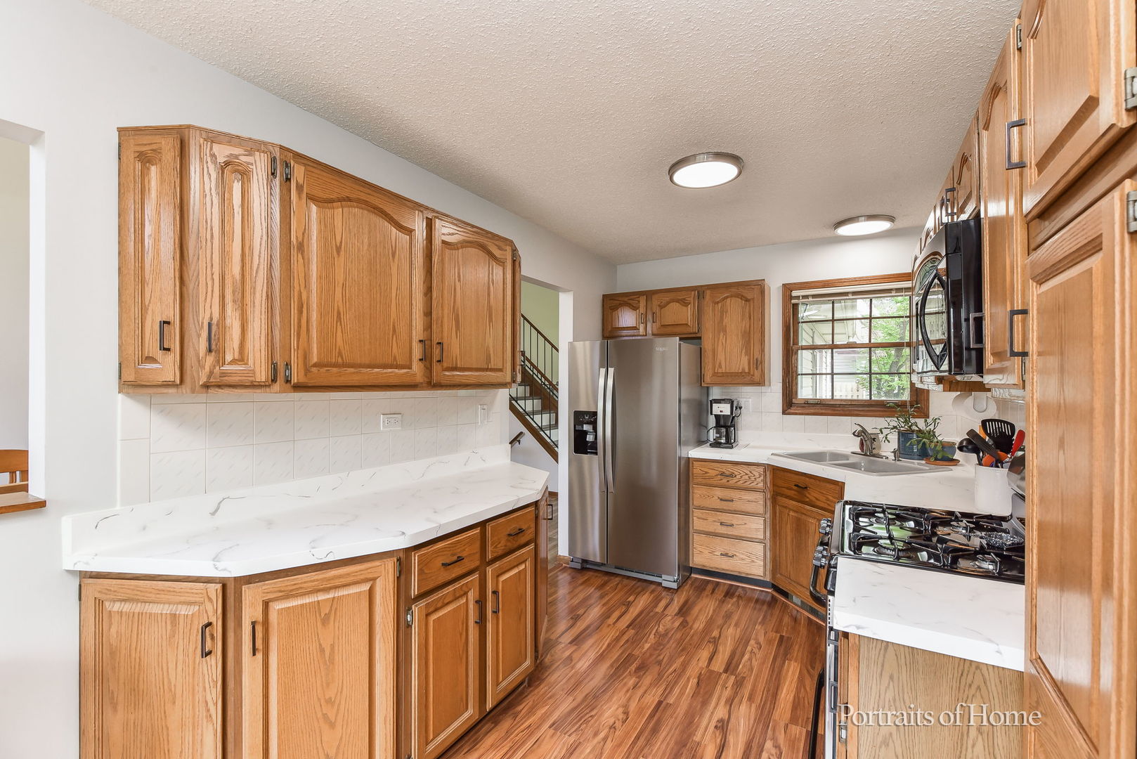 1920 Howe Lane Hanover Park, IL 60133 - Photo 11 of 25 a kitchen with stainless steel appliances granite countertop a sink stove and refrigerator