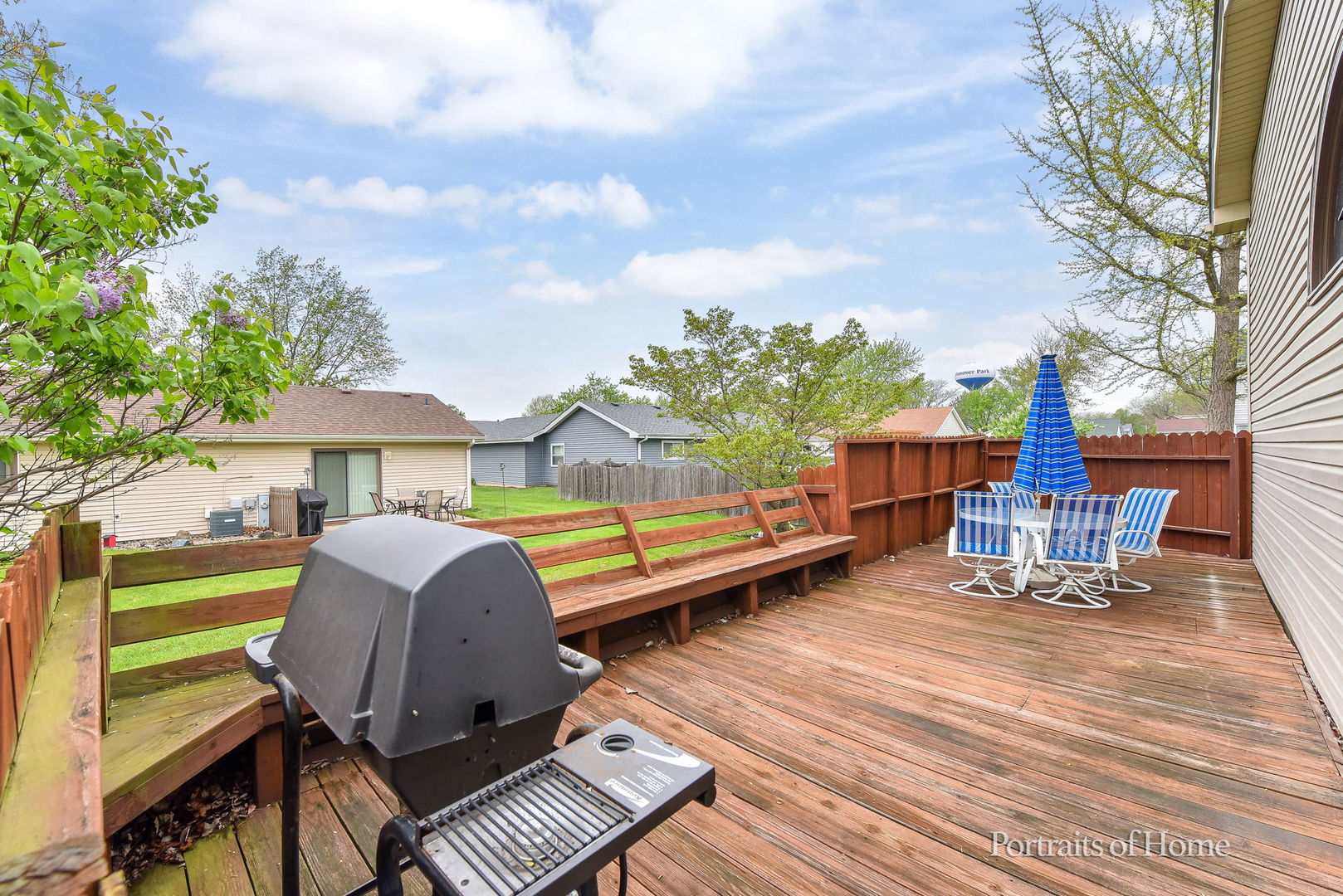 1920 Howe Lane Hanover Park, IL 60133 - Photo 2 of 25 a view of a roof deck with table and chairs a barbeque with wooden floor and fence