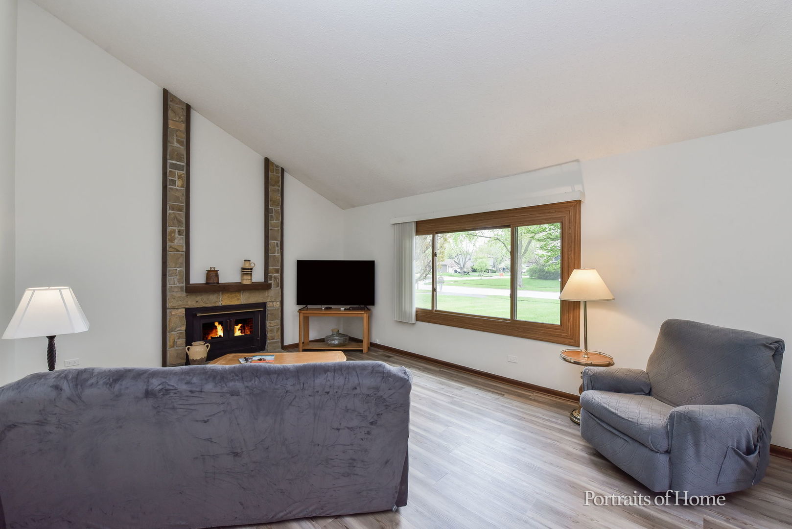 1920 Howe Lane Hanover Park, IL 60133 - Photo 6 of 25 a living room with furniture a fireplace and a flat screen tv