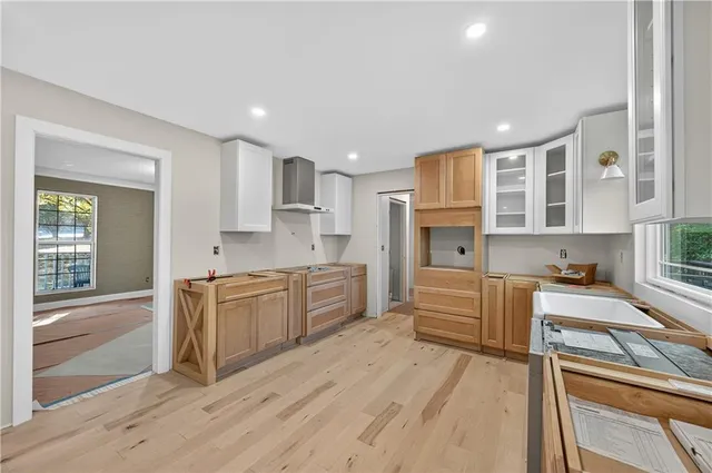 a large kitchen with stainless steel appliances granite countertop a stove and a refrigerator