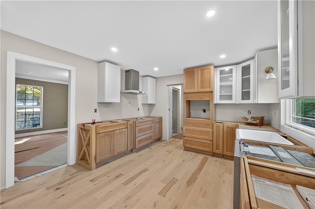 4460 Suwanee Dam Road Suwanee, GA 30024 - Photo 14 of 38 a large kitchen with stainless steel appliances granite countertop a stove and a refrigerator