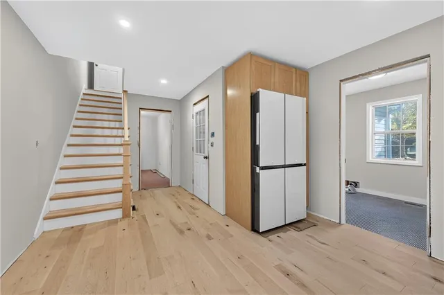 a view of a kitchen with wooden floor and stairs