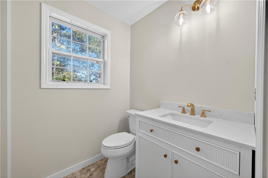 4460 Suwanee Dam Road Suwanee, GA 30024 - Photo 28 of 38 a bathroom with a toilet a sink and a window