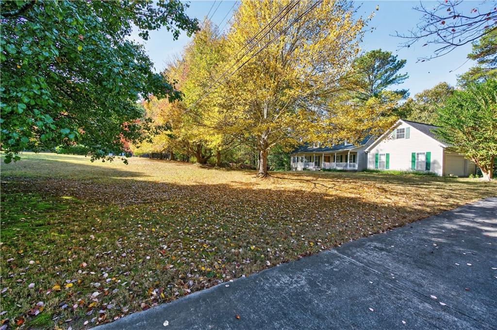 4460 Suwanee Dam Road Suwanee, GA 30024 - Photo 38 of 38 a view of house with backyard and tree