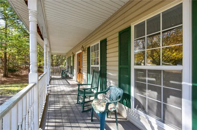 a view of a balcony with chair and floor to ceiling window