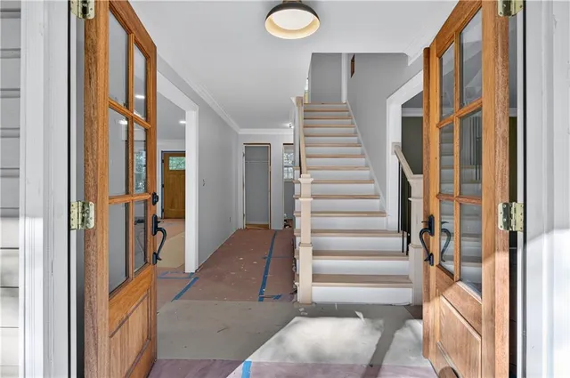 a view of entryway with furniture and windows