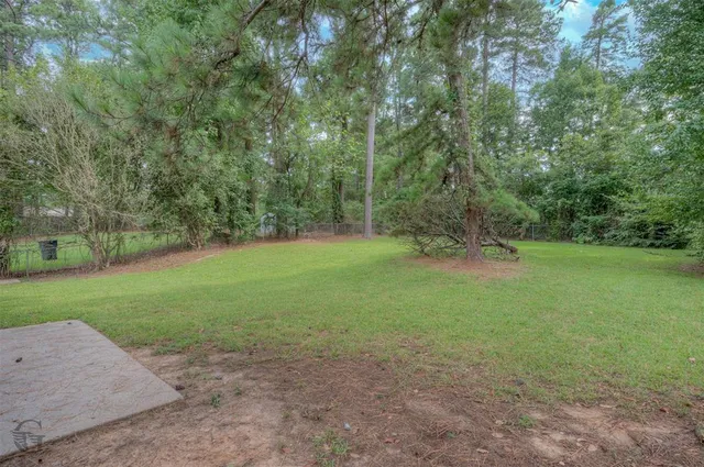 a view of a field with trees in background