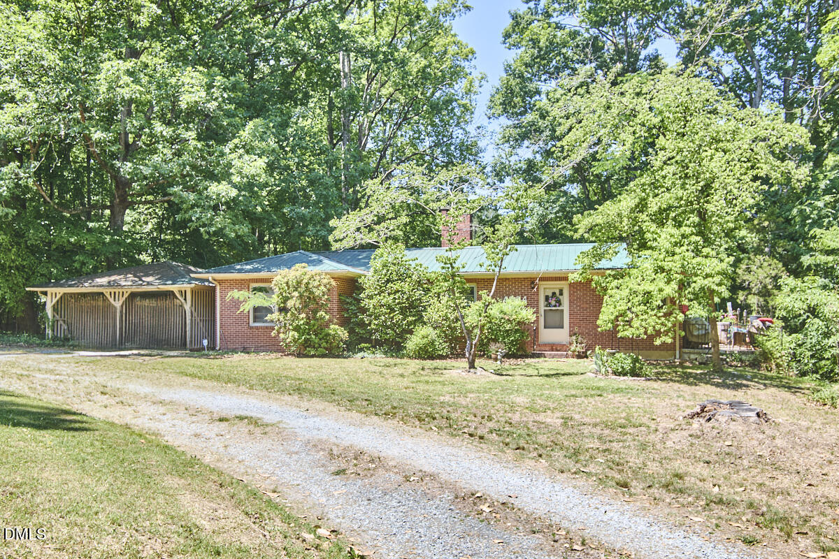 4204 Kerley Road Durham, NC 27705 - Photo 6 of 34 a front view of a house with a yard and trees