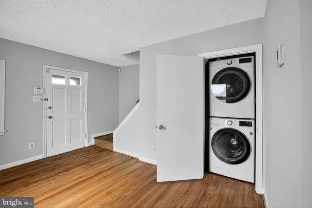 a view of a livingroom with wooden floor and a ceiling fan