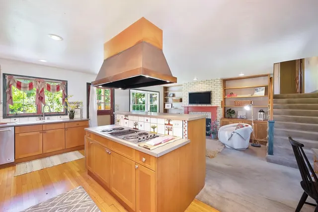 a kitchen with stainless steel appliances granite countertop a sink stove and wooden cabinets
