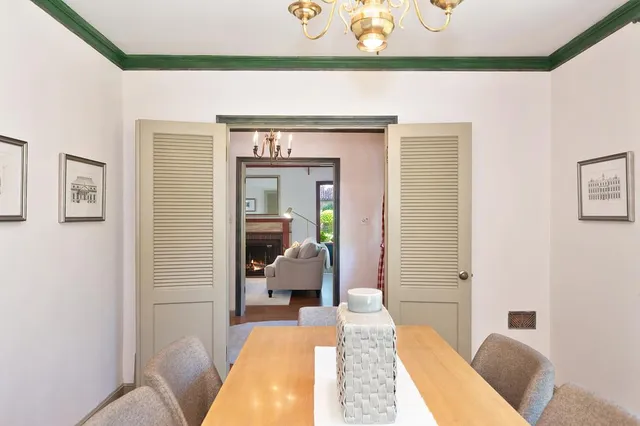 a bedroom with a bed mirror and a window