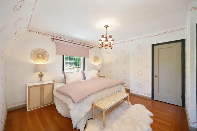 a spacious bedroom with a large bed couch and a window