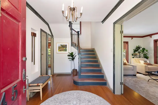 a view of entryway livingroom and hall with wooden floor