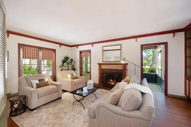 a living room with furniture fireplace and potted plants