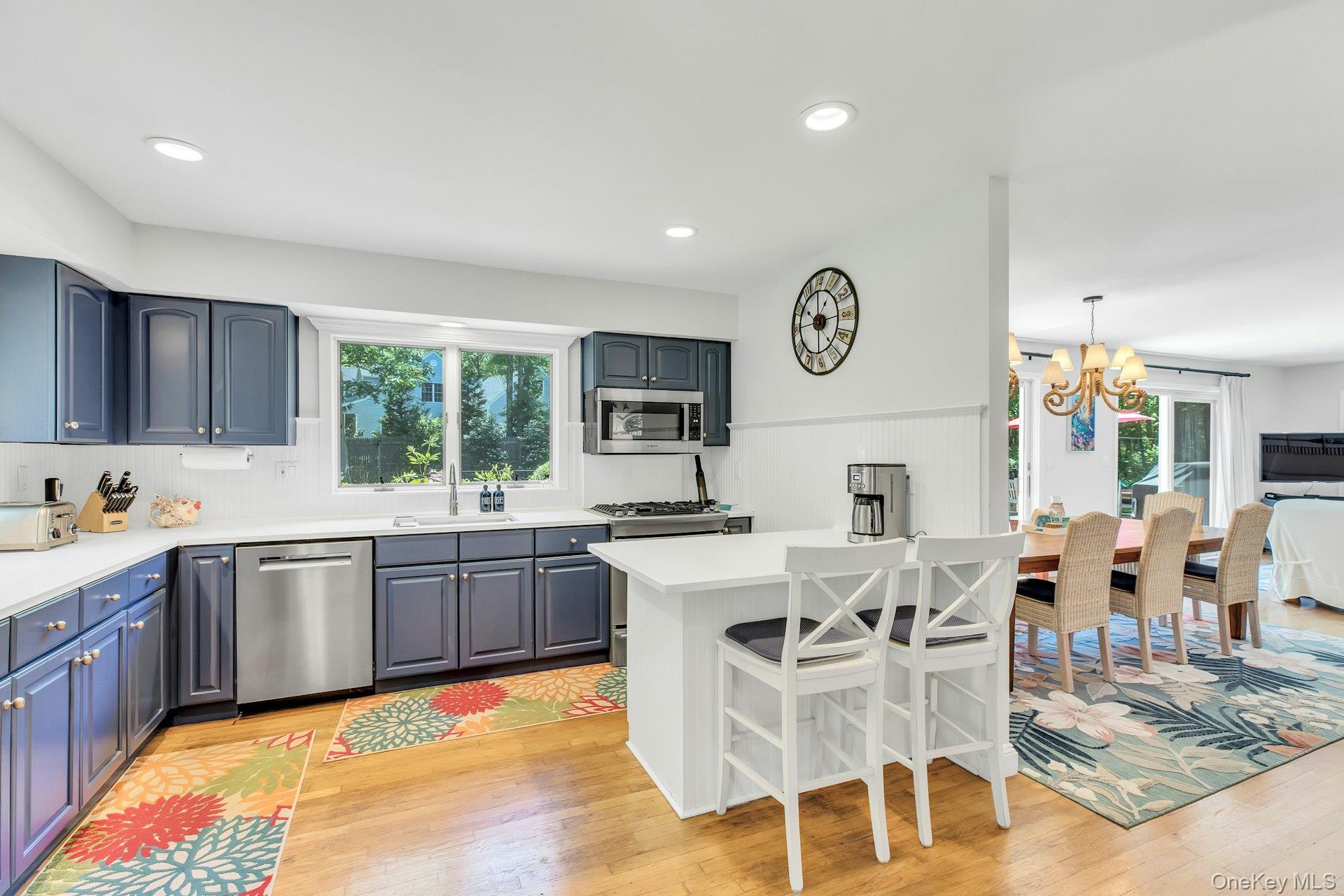 16 Hildreth Road Hampton Bays, NY 11946 - Photo 9 of 29 a kitchen with a sink chairs and stove
