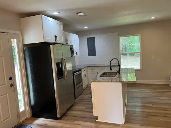 a kitchen with a refrigerator sink and stove