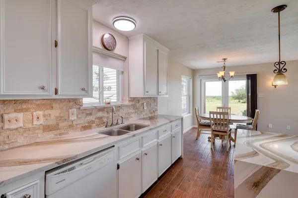 a kitchen with lots of counter space a sink and appliances