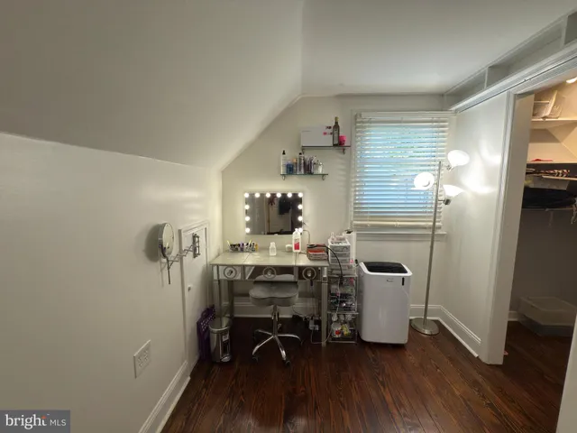 a room with furniture a window and wooden floor