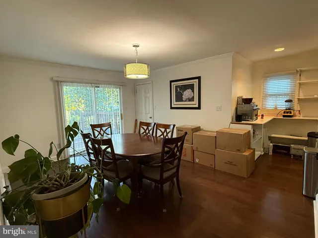 a view of a dining room with furniture and a potted plant