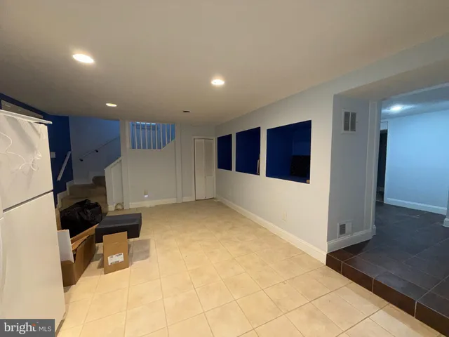 a room with furniture and a refrigerator