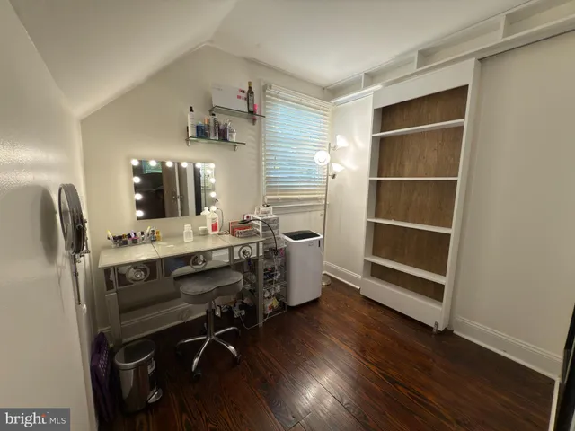 a view of a workspace with furniture and wooden floor