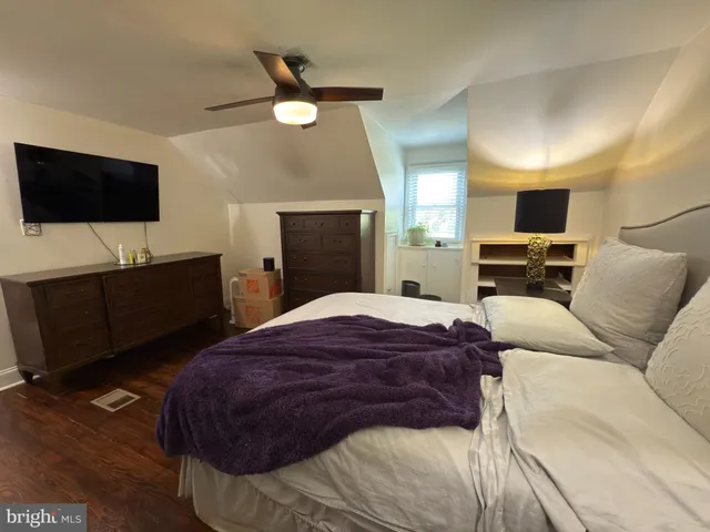 a bedroom with a bed and a television