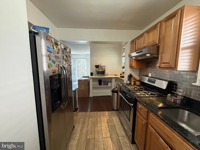 a kitchen with a stove a refrigerator and a sink