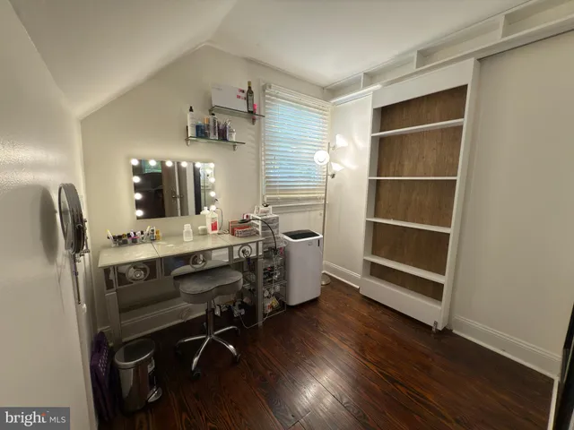 a view of a workspace with furniture and wooden floor