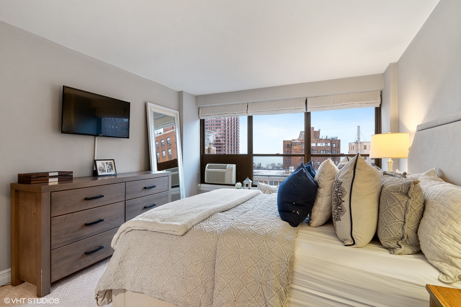 2930 North Sheridan Road, Unit 1611 Chicago, IL 60657 - Photo 12 of 18 a bedroom with a bed and a flat screen tv