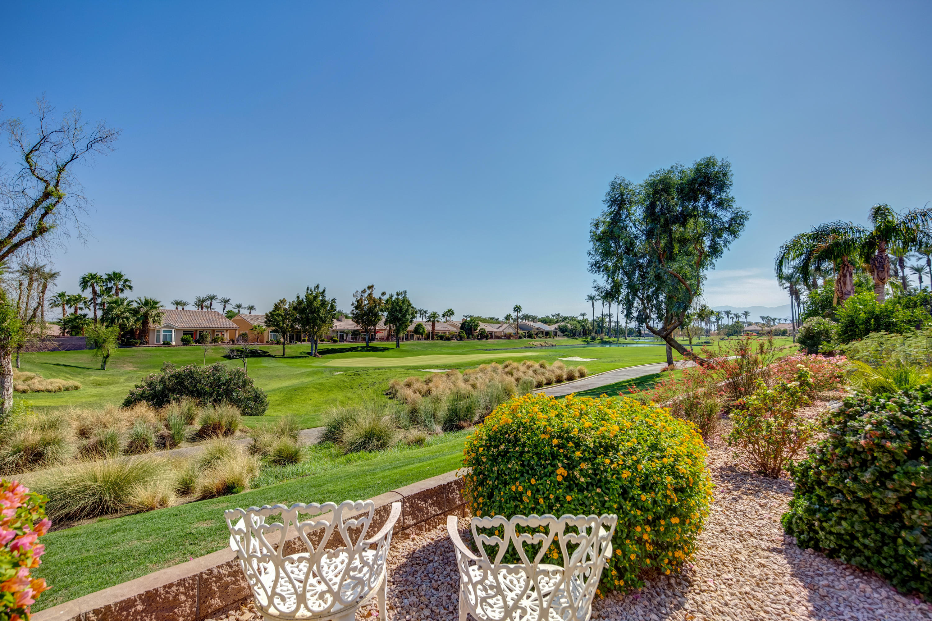 35076 Moorbrook Road Palm Desert, CA 92211 - Photo 1 of 45 a view of a swimming pool with a garden