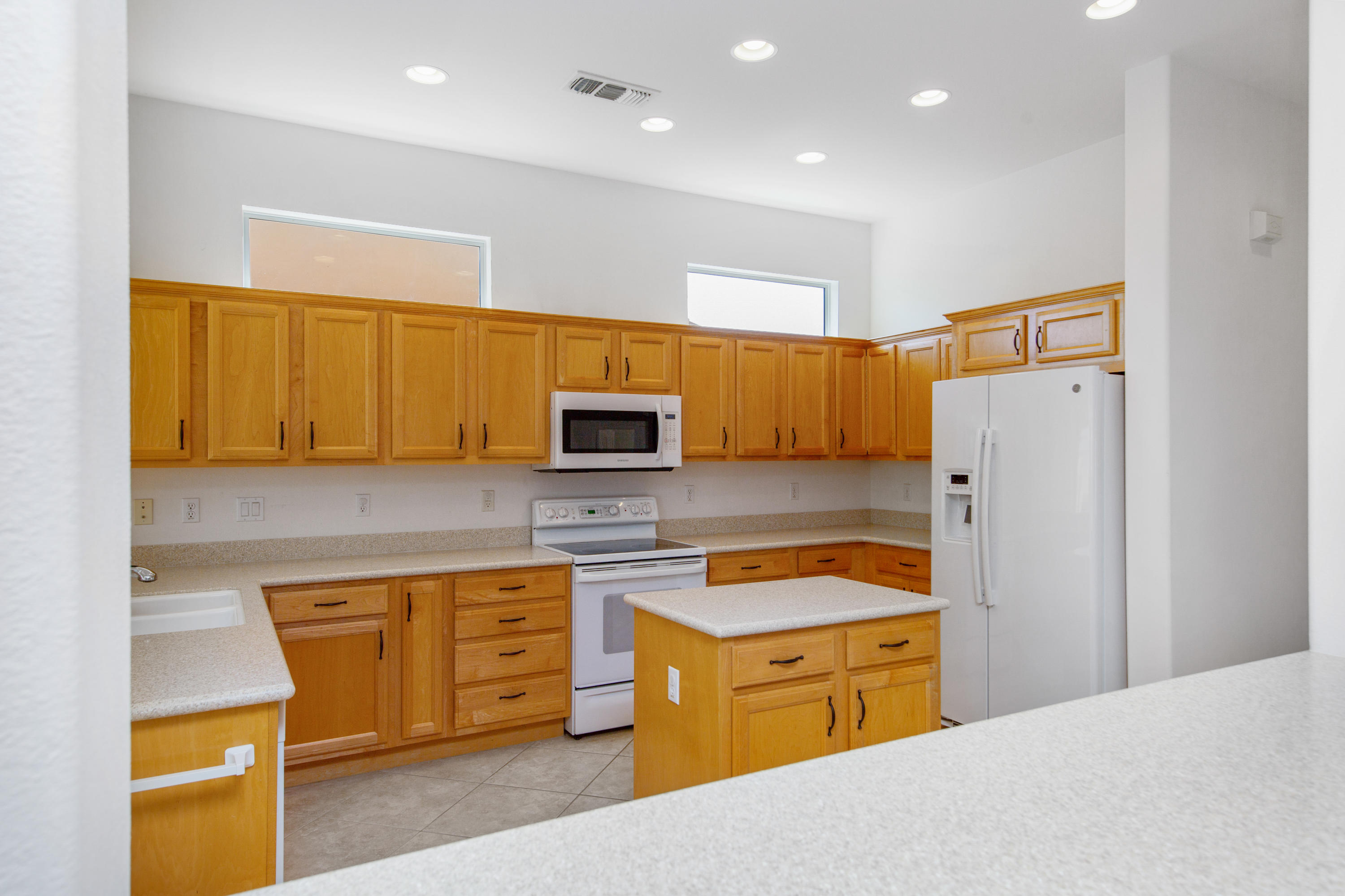 35076 Moorbrook Road Palm Desert, CA 92211 - Photo 20 of 45 a kitchen with a refrigerator a stove top oven a sink and dishwasher