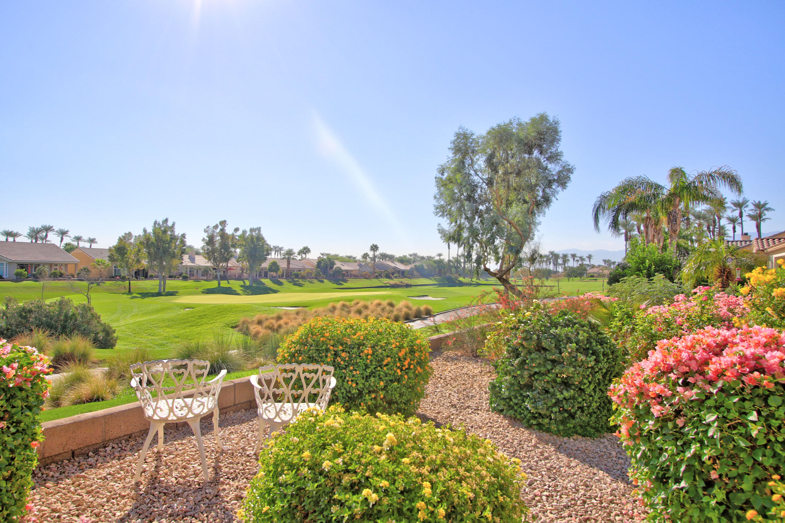 35076 Moorbrook Road Palm Desert, CA 92211 - Photo 3 of 45 a view of a lake with a garden