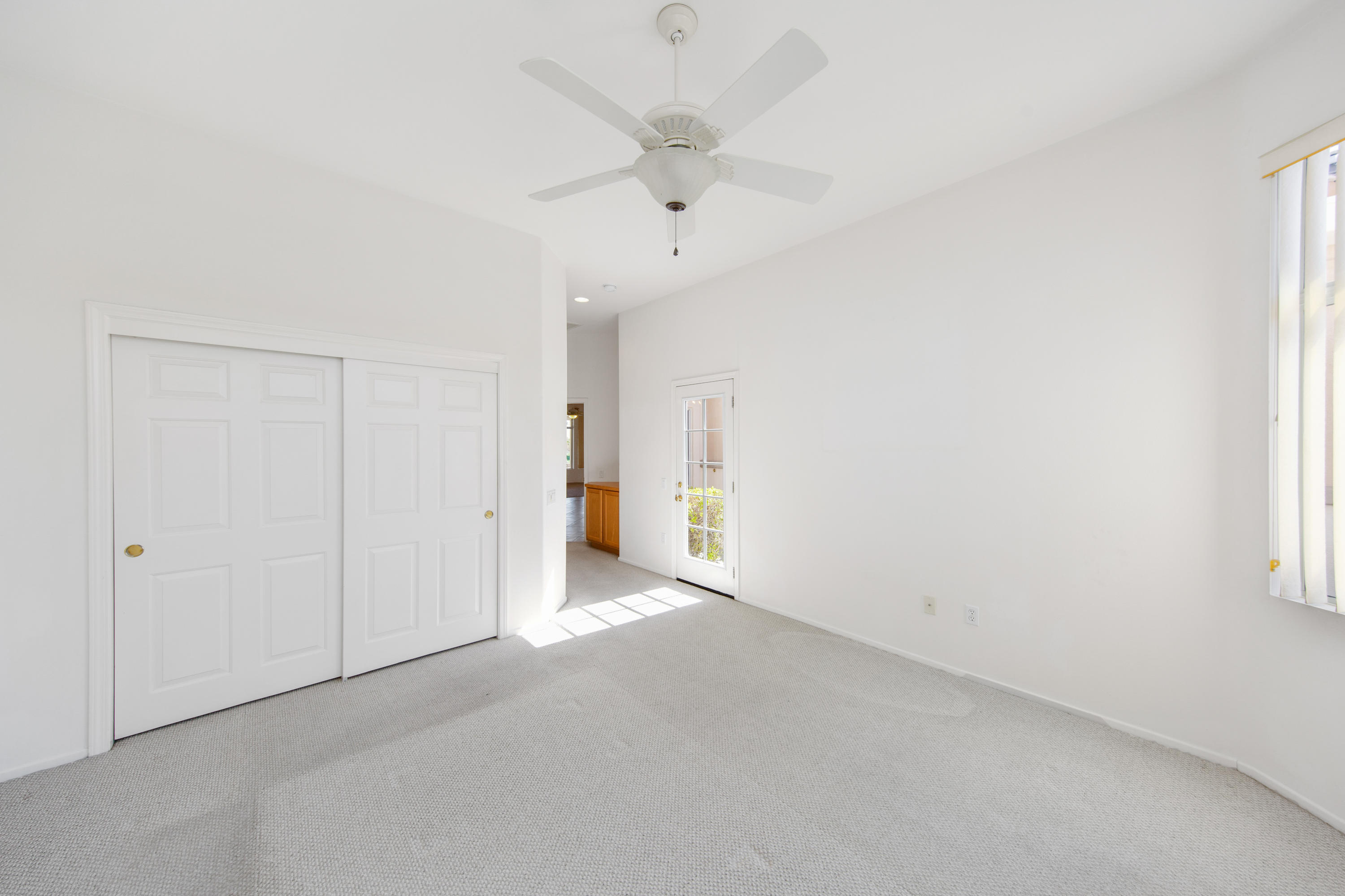 35076 Moorbrook Road Palm Desert, CA 92211 - Photo 32 of 45 an empty room with a ceiling fan and a window
