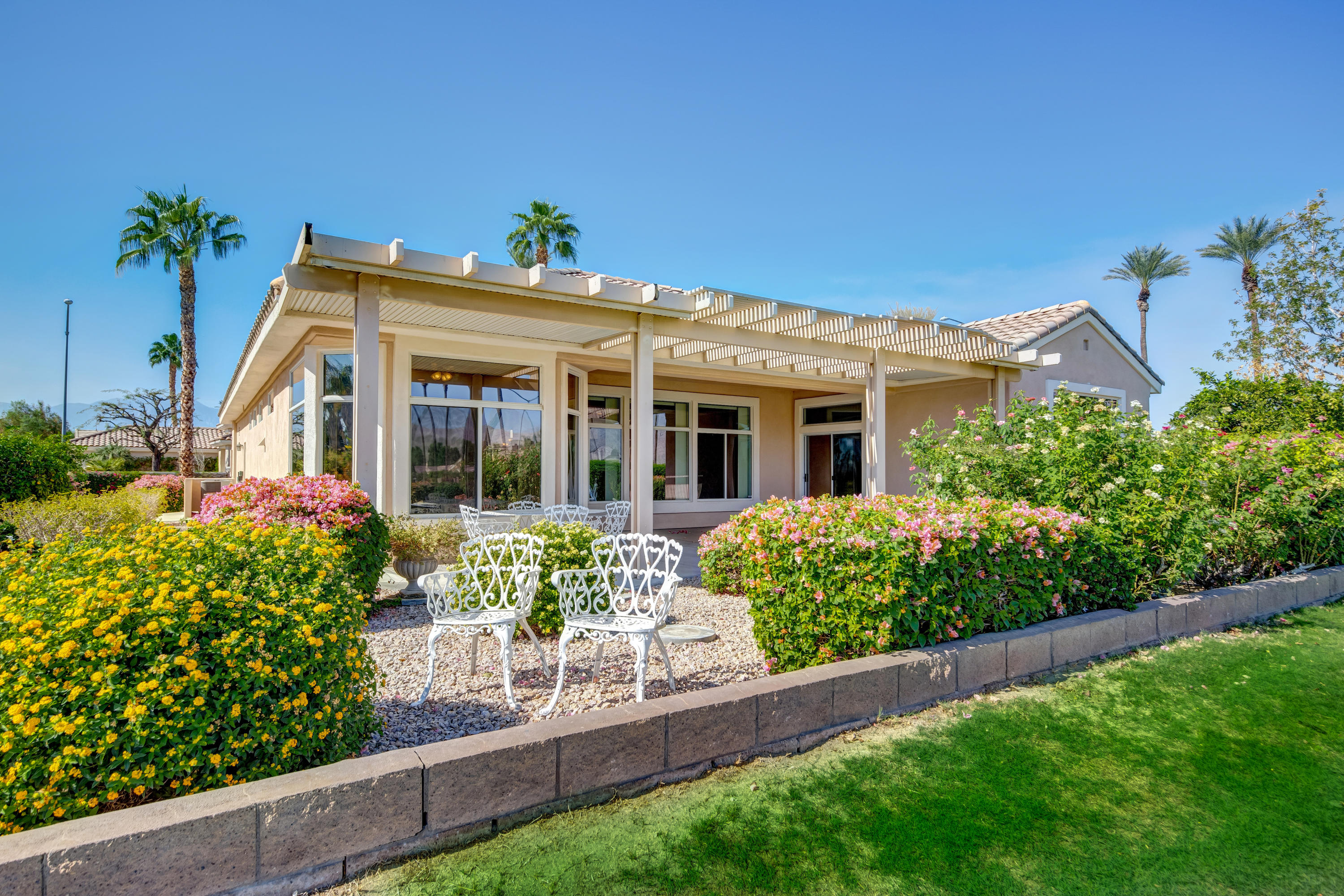 35076 Moorbrook Road Palm Desert, CA 92211 - Photo 9 of 45 a front view of a house with a yard